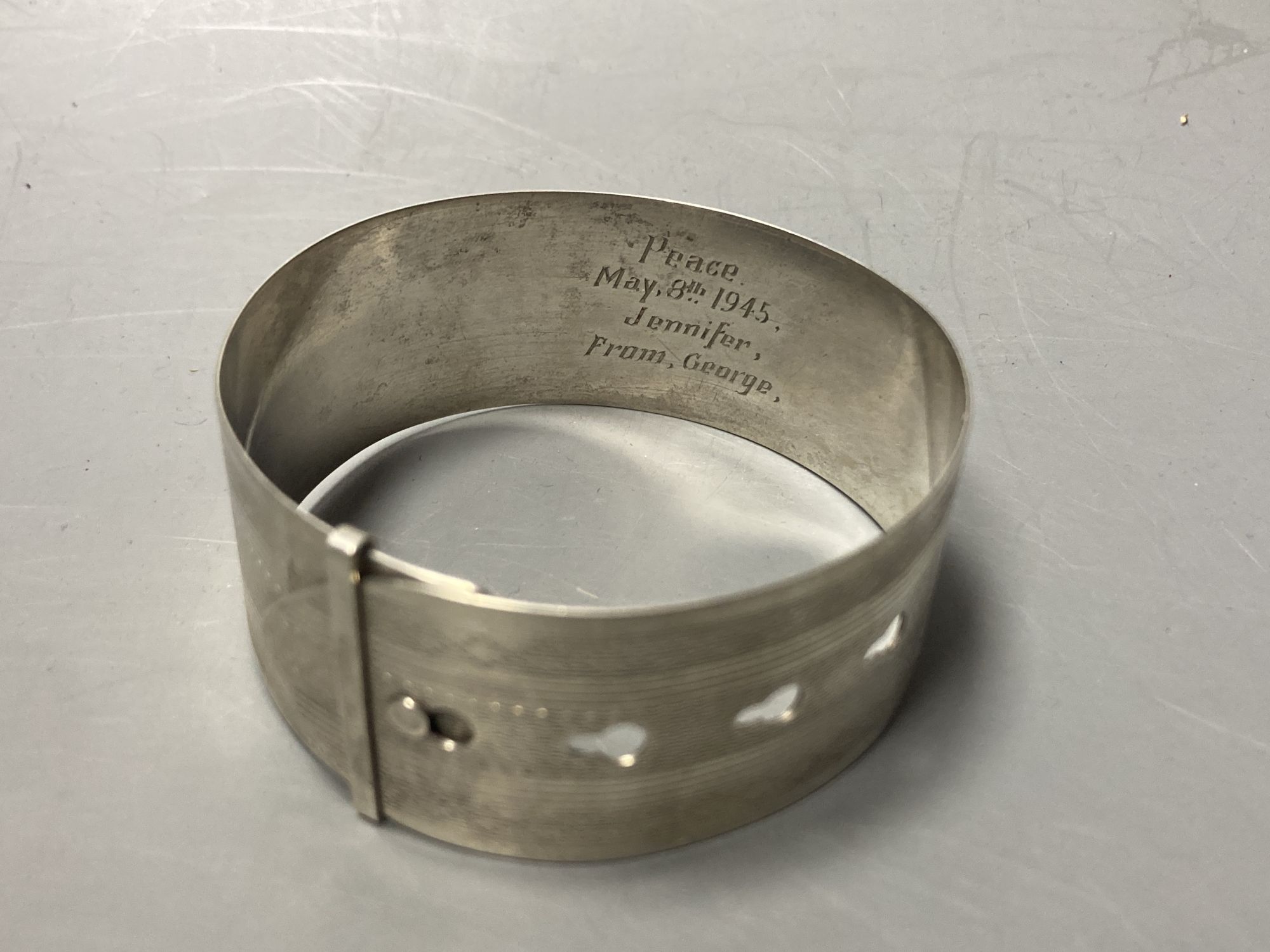 A cased silver handled button hook and shoe horn, a silver and enamel hand mirror, a silver bangle and small silver model ship